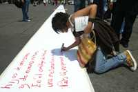 Una transeúnte se sumó, de manera espontánea, a la propuesta de Poema Gigante que se desarrolló en el Zócalo capitalino