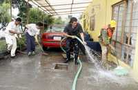 Vecinos de la calle Eduardo Olivares, de la colonia Palmatitla, en la delegación Gustavo A. Madero, se dieron a la tarea de limpiar sus viviendas tras la inundación de ayer por el desbordamiento del río Maximalaco