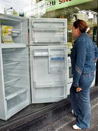 Una joven observa aparatos electrodomésticos en una tienda