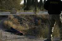 Elementos de la Agencia Estatal de Investigaciones realizan labores de peritaje en el sitio en que fue hallado el cadáver de un hombre junto a las vías del tren en el parque industrial Omega, al sur de Ciudad Juárez, Chihuahua