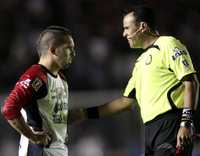 El silbante Francisco Chacón Gutiérrez y Giancarlo Maldonado, durante el partido Cruz Azul-Atlante